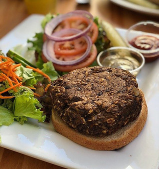 How to start going vegan - Delicious vegan bean burger in a bun with salad on the side