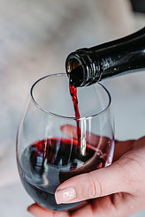 Red wine being poured into a glass - drink less alcohol to not gain weight over the holidays